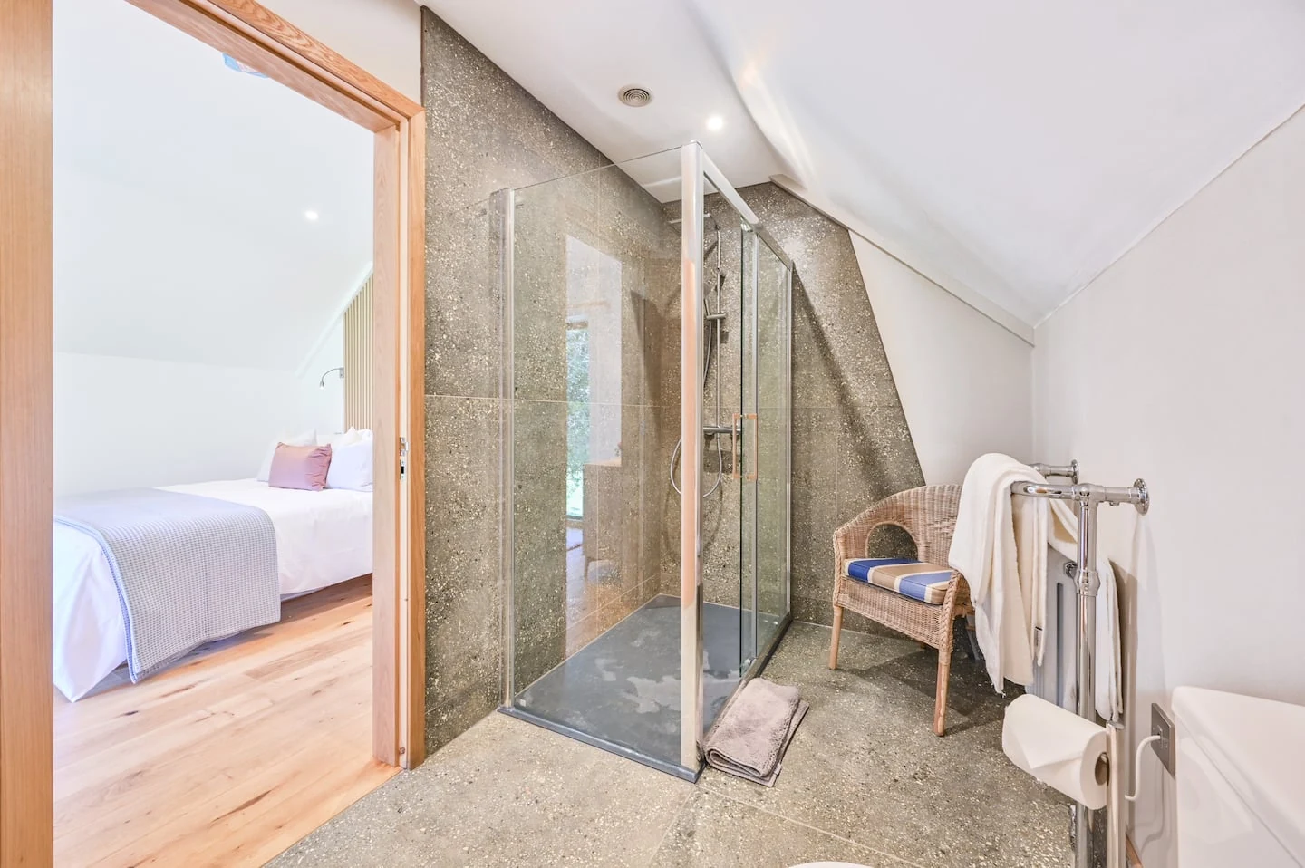 Glass shower beside the bedroom doorway