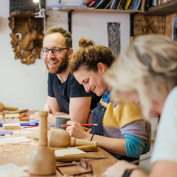 Students working at a woodcarving bench