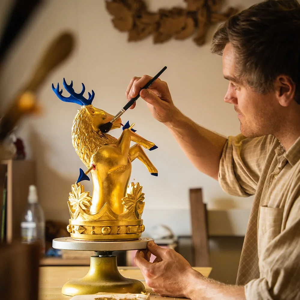 William Barsley painting details on a gilded carved figure