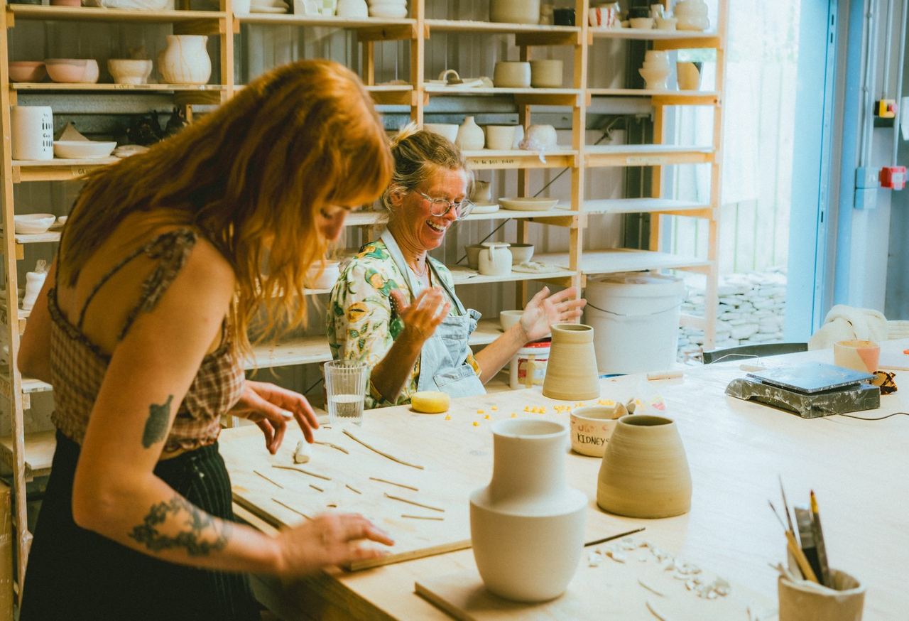 People making pottery at the studio tables at Outside Devon