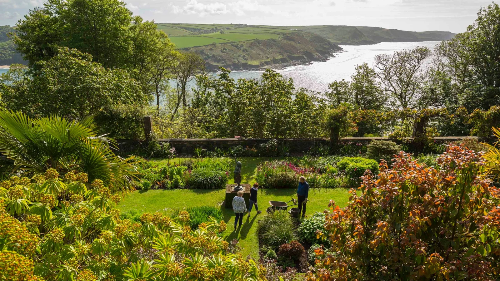 Visitors among the garden terraces above the coastline