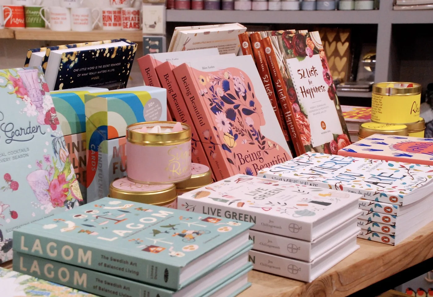 Books, cards, candles and gifts displayed on a table inside Penelopetom