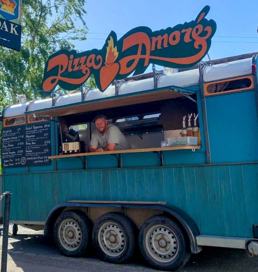 The turquoise Pizza Amore van with its serving hatch open