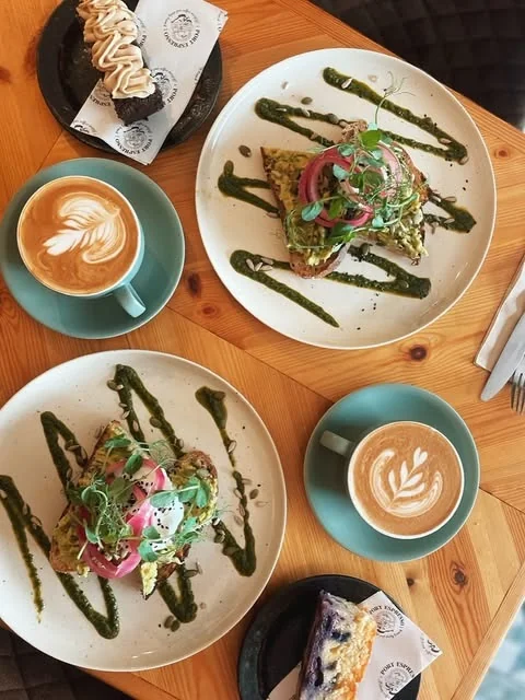 Brunch plates and two coffees viewed from above