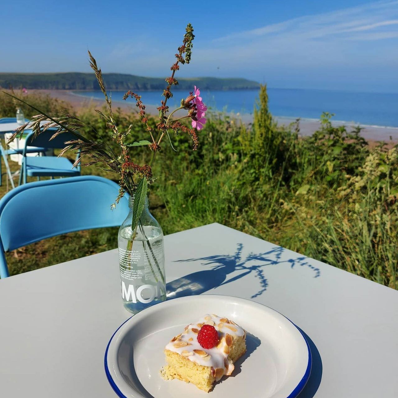 Cake on an outdoor table overlooking the coast