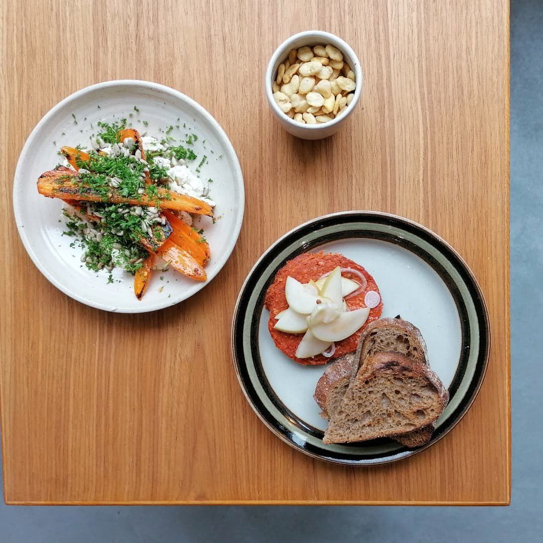 Small plates arranged on a wooden table at Pullo