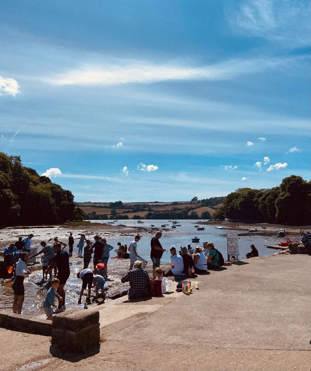 People crabbing and gathering at the quay beside The River Shack