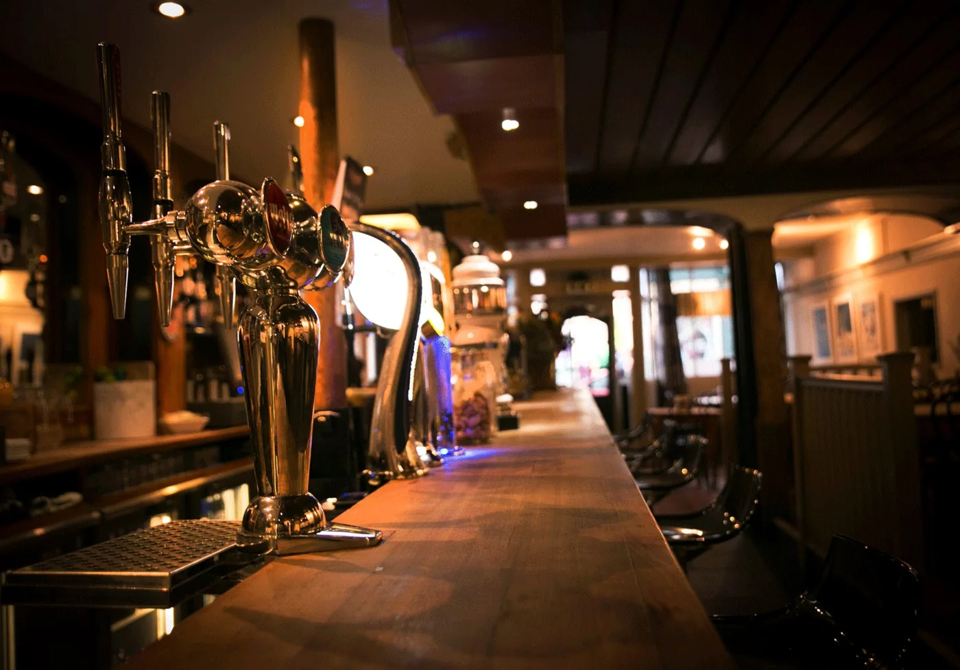 The warmly lit bar and taps at Rumour