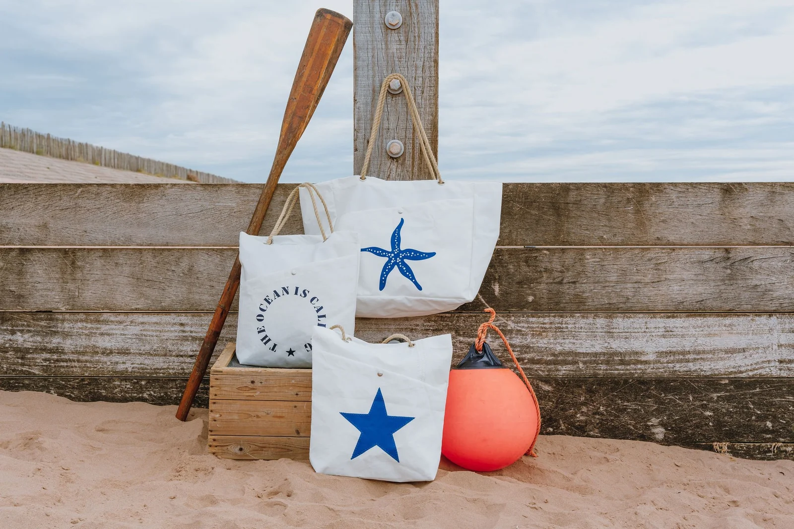 White sailcloth tote bags with bright coastal designs
