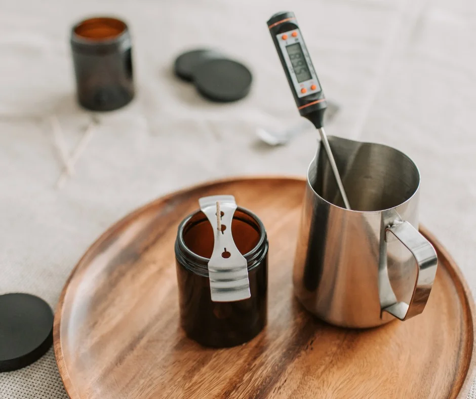 Wax pouring jugs and thermometers on a workshop table