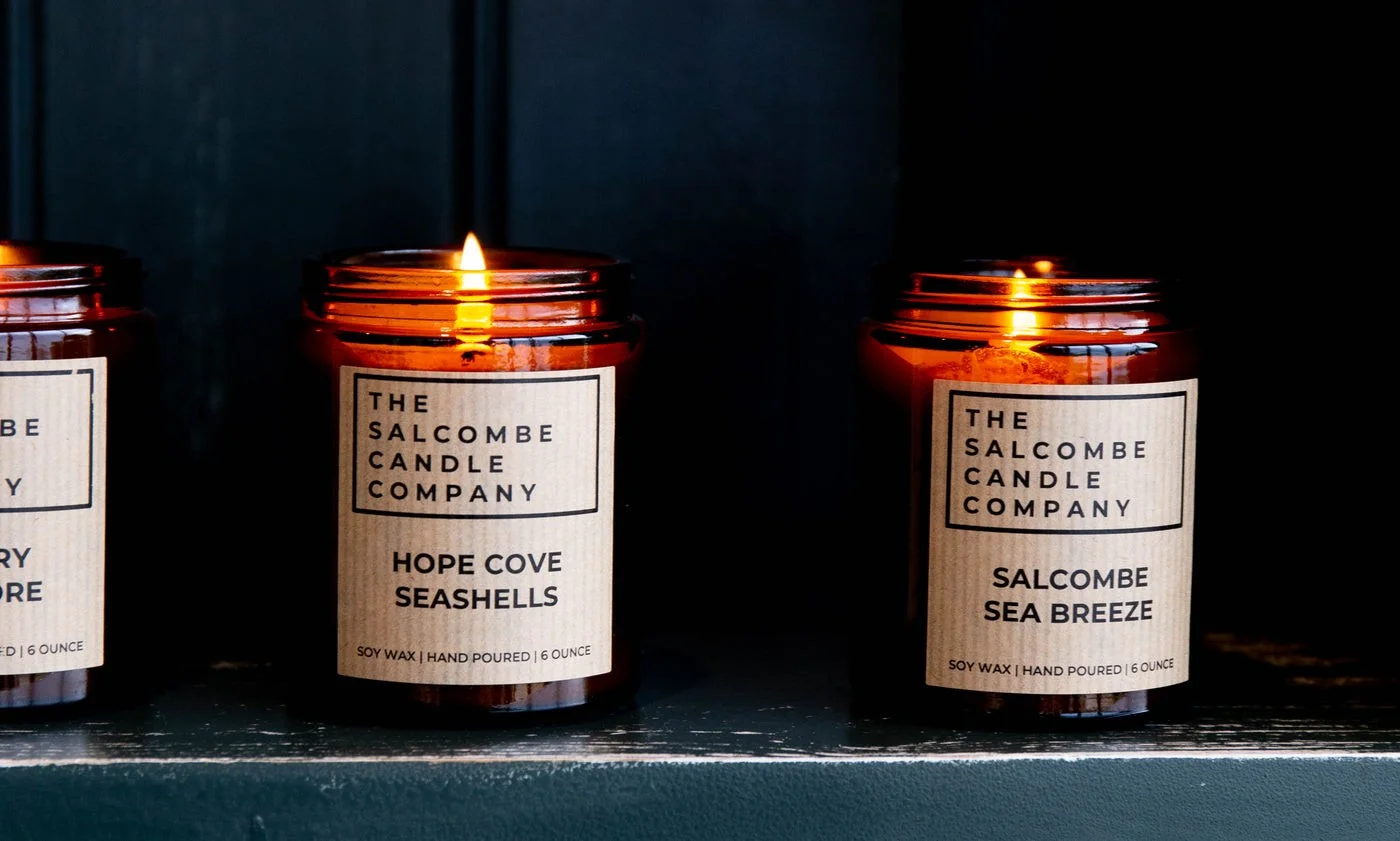 Three lit Salcombe Candle Company candles