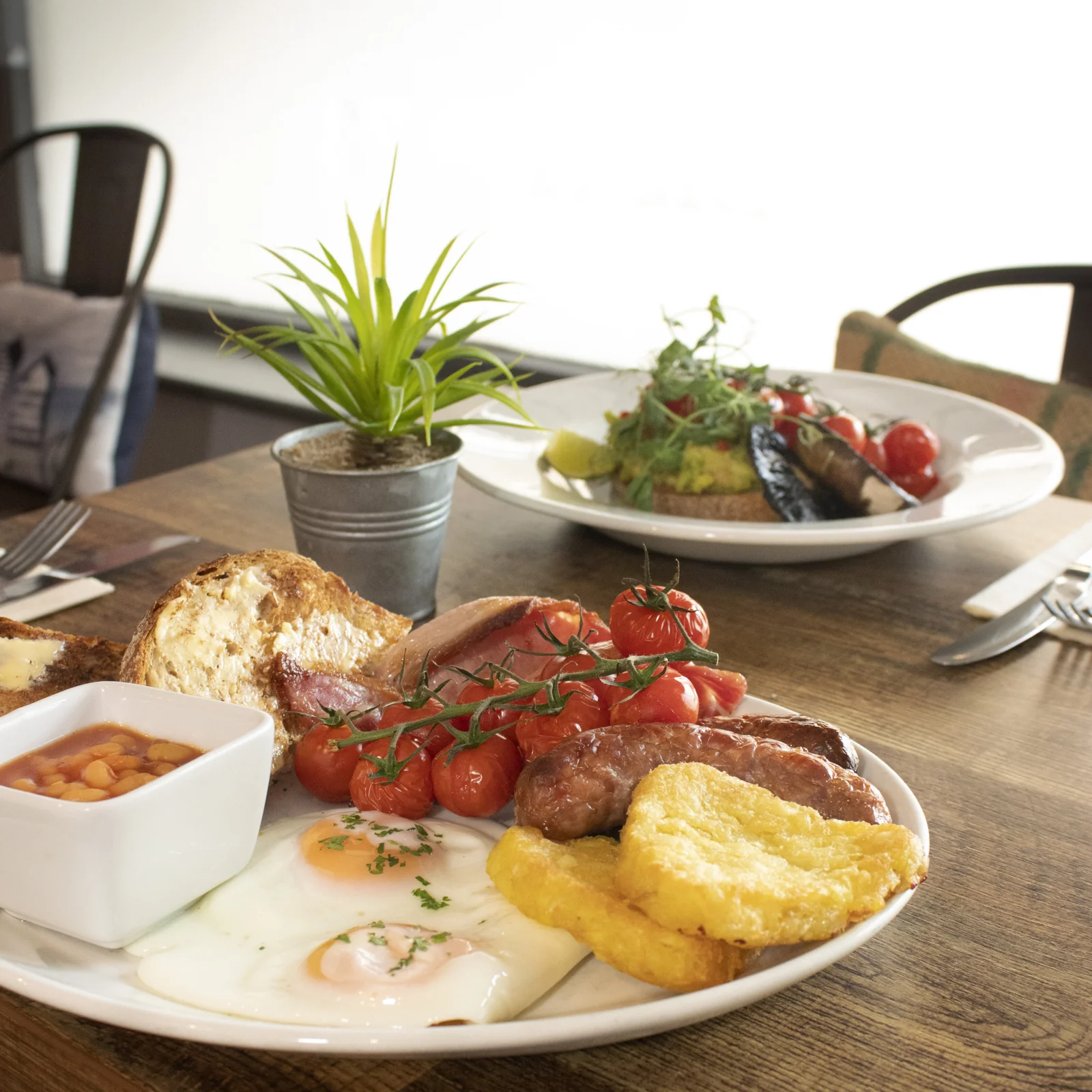 Breakfast plates on a wooden table at Salcombe Coffee Company