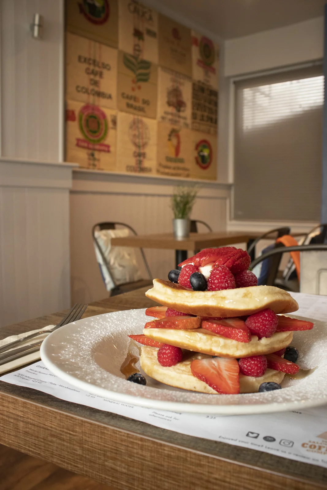 Pancakes layered with strawberries and blueberries