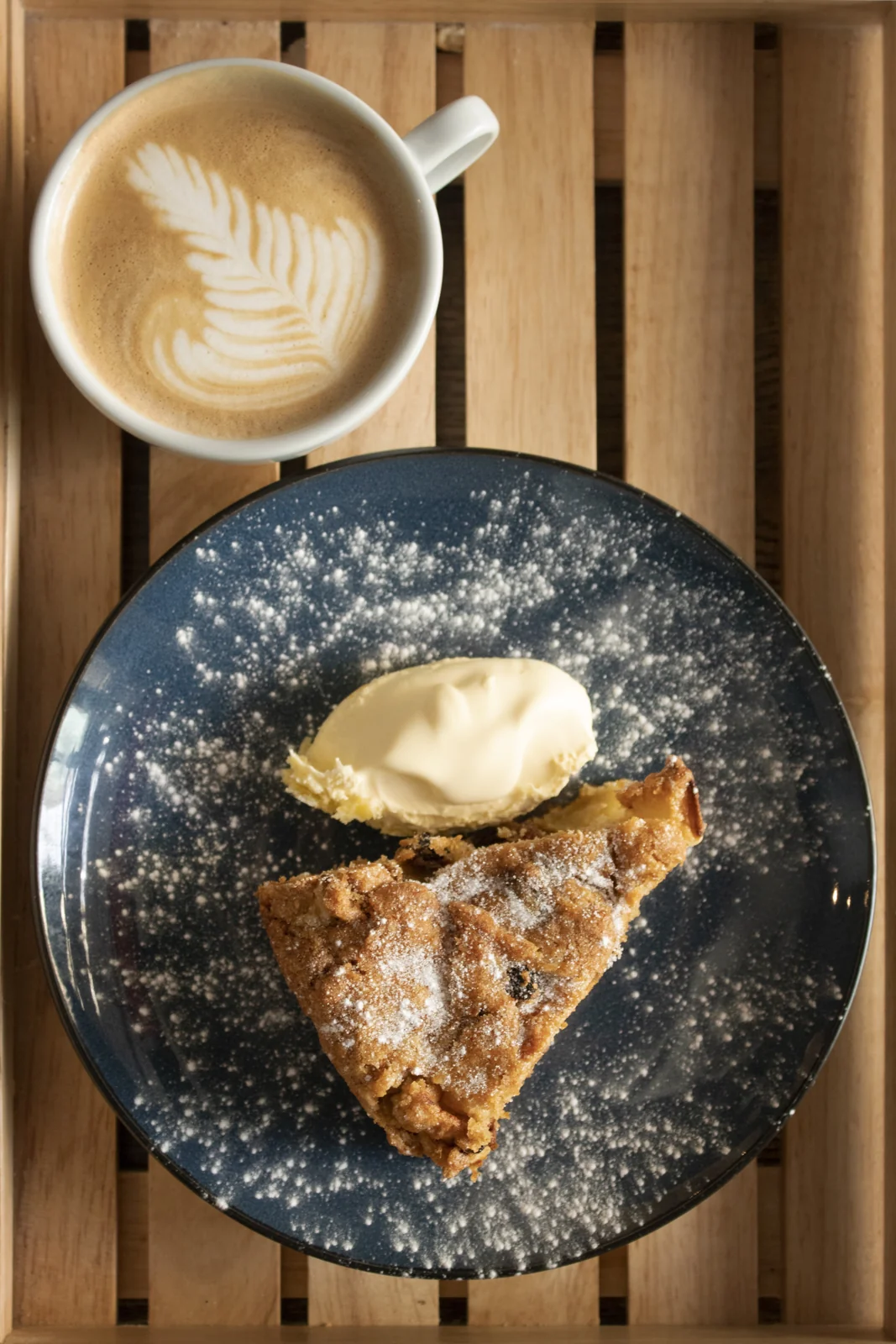 Apple cake with cream and a cup of coffee