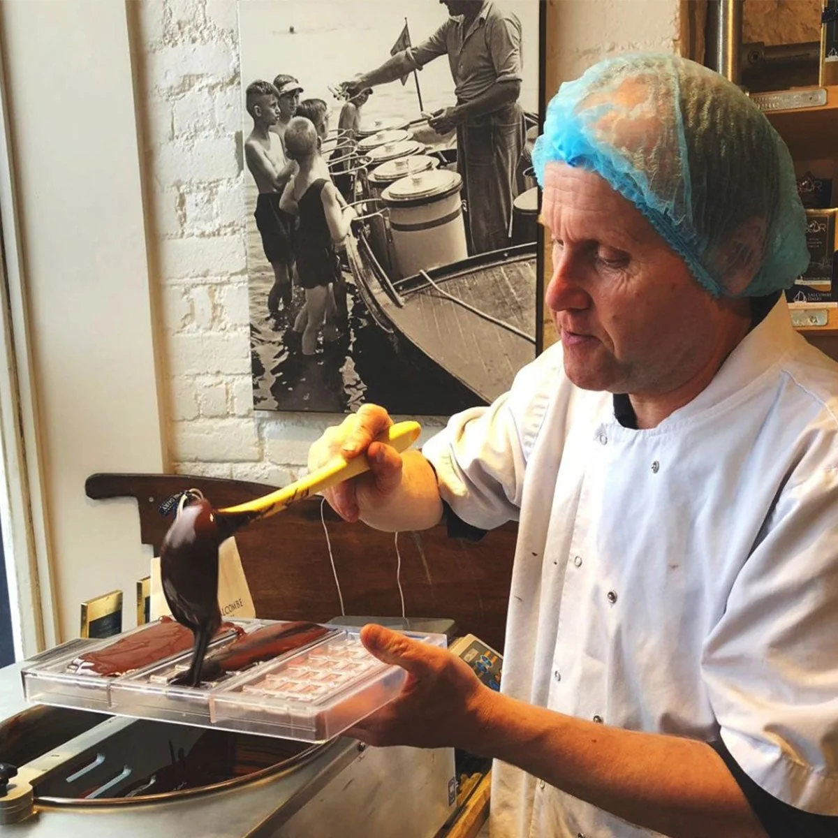 A Salcombe Dairy chocolate maker filling a mould