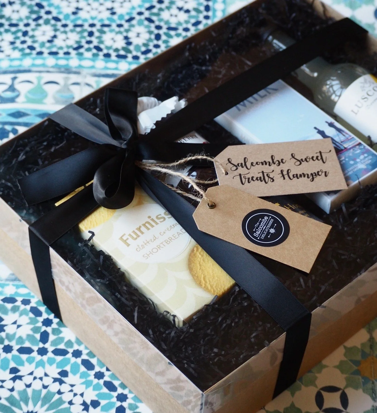 A gift hamper wrapped with ribbon at Salcombe Delicatessen