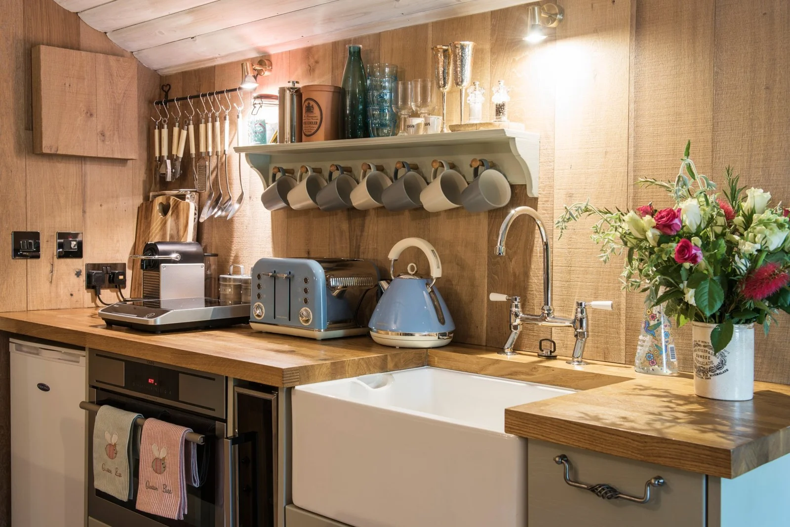 Small kitchen with oak worktops and blue cabinetry
