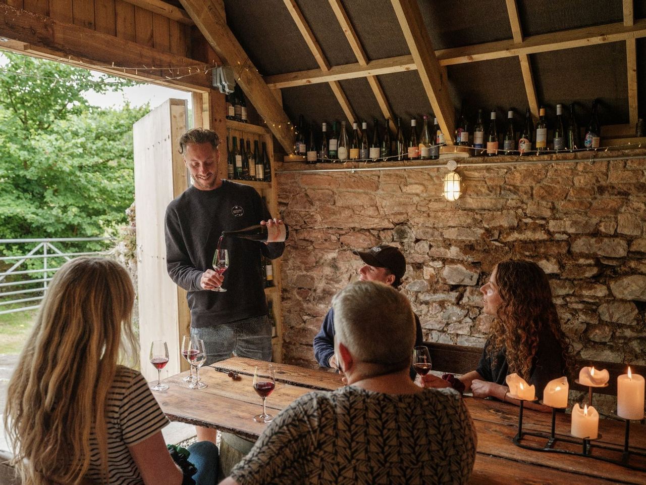 A tasting taking place inside a stone building at Sandridge Barton