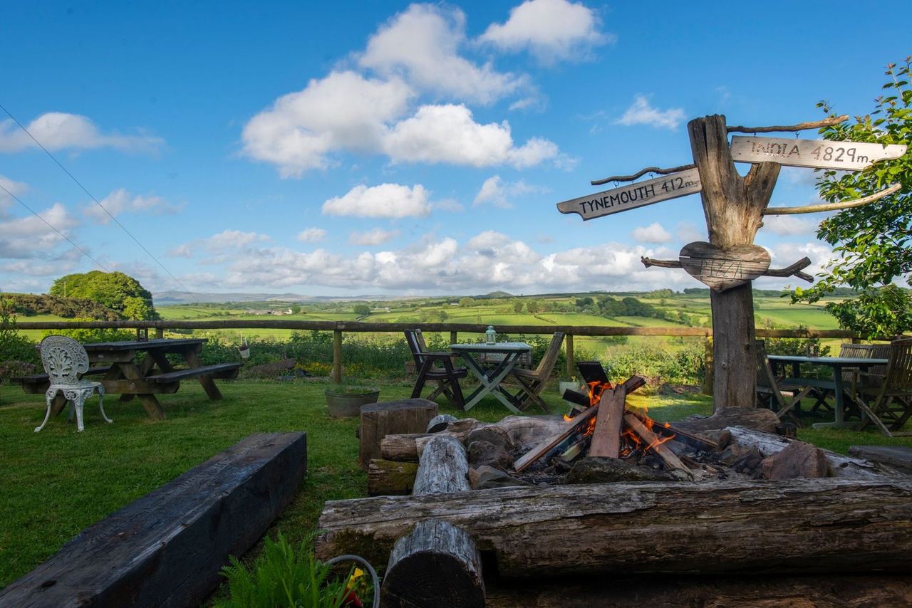 Picnic tables overlooking green Devon fields