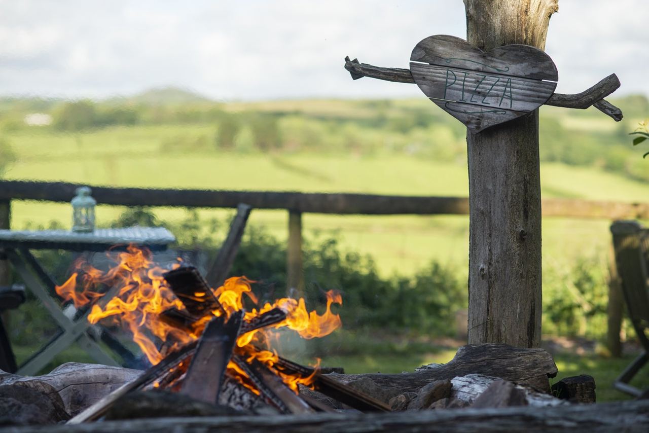 An open fire with fields stretching beyond it