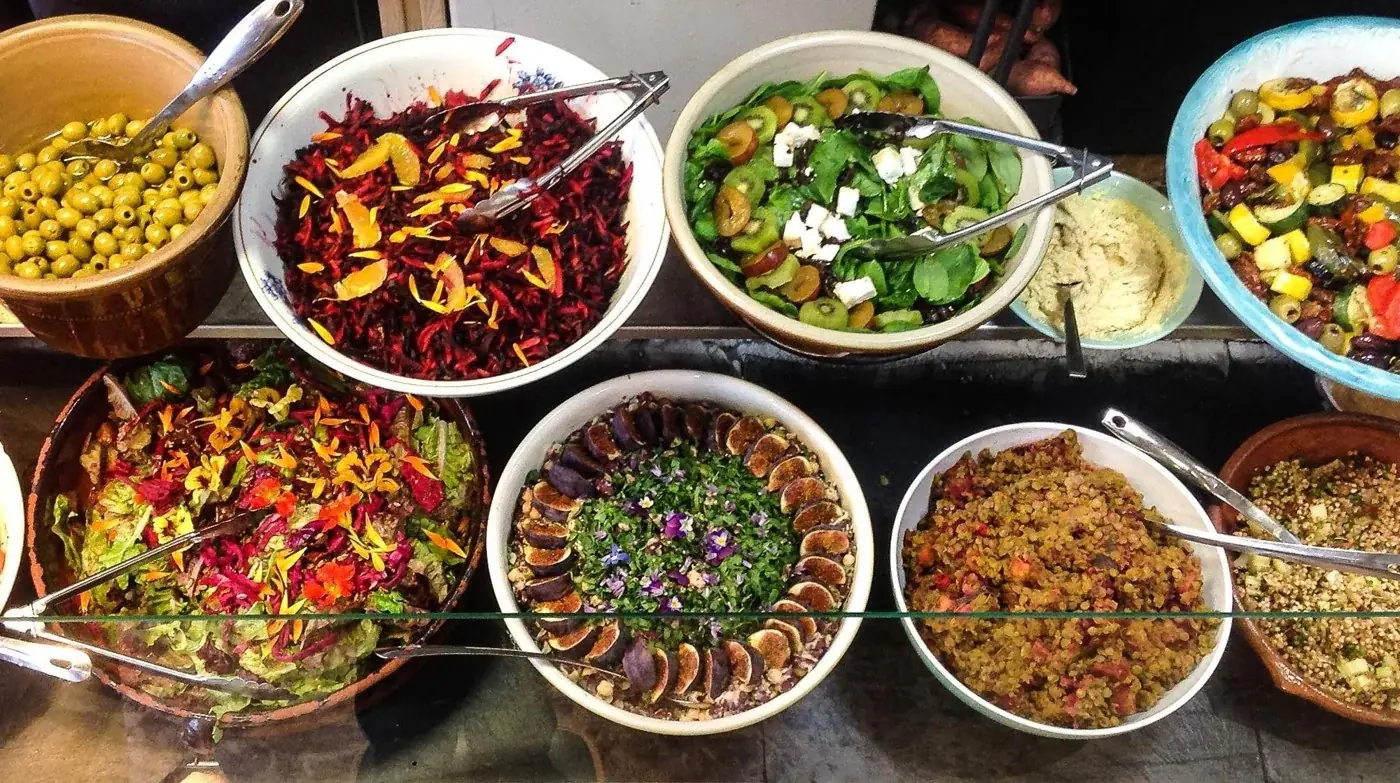An overhead view of colourful buffet dishes at Seeds 2 Totnes