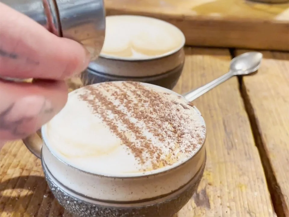 A cappuccino being finished at Seeds 2 Totnes