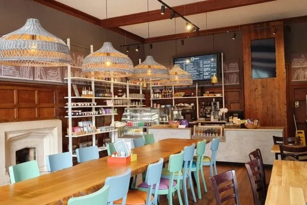 Seven Dials interior with wooden tables and blue chairs