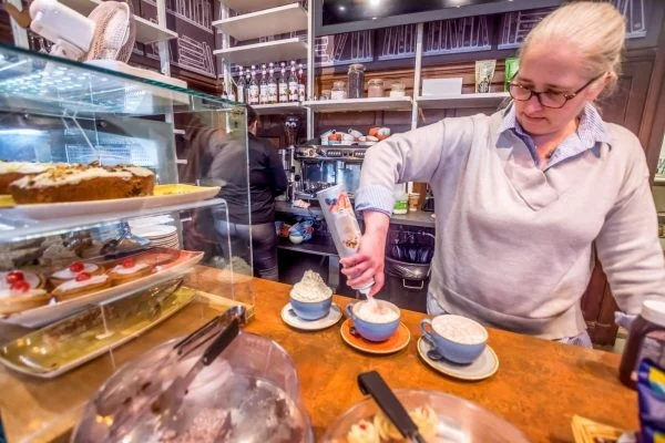 Coffee being prepared beside cakes at Seven Dials