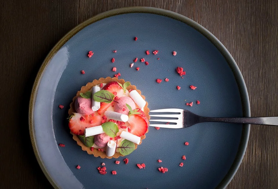 Strawberries and cream on a dark plate from the Ship Inn’s menu photography