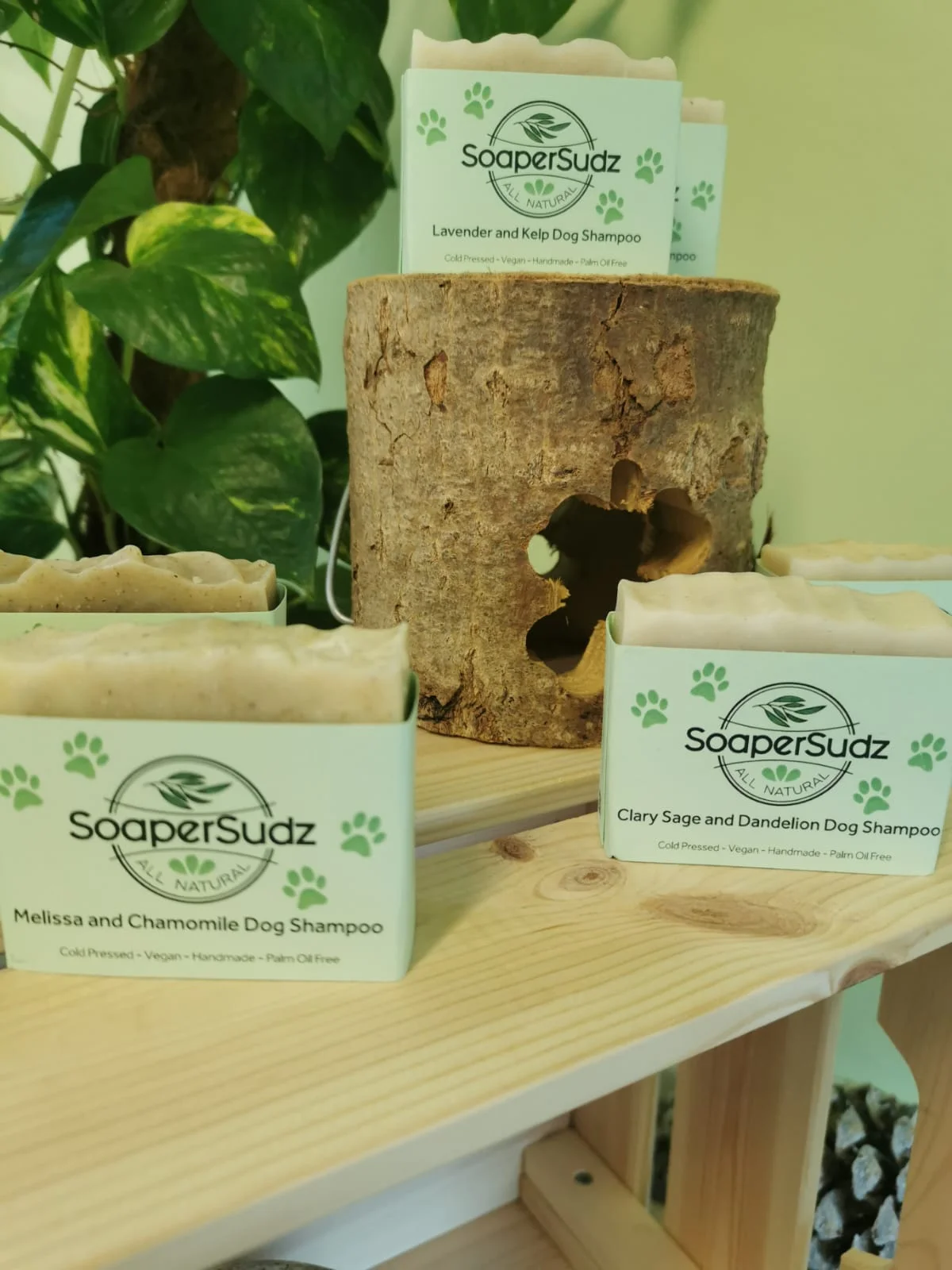 SoaperSudz handmade bars displayed beside a wooden log