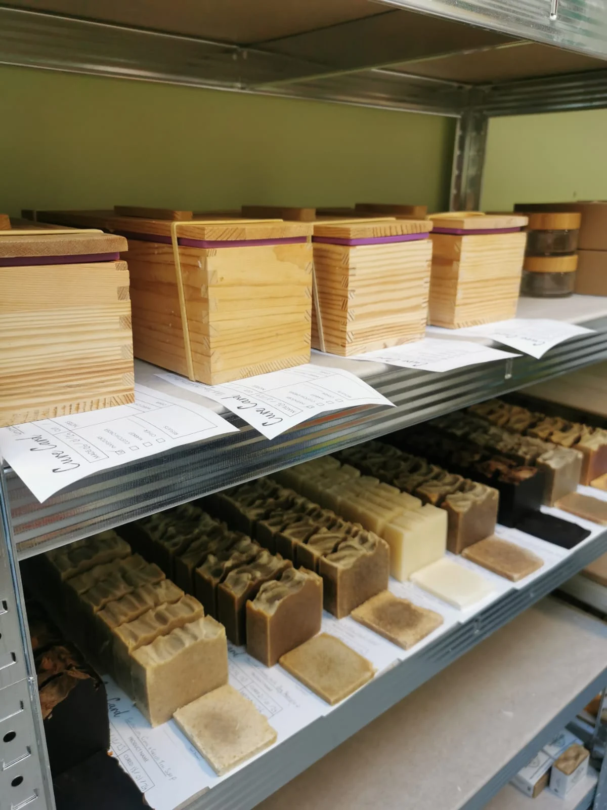 SoaperSudz soap bars and moulds on workshop shelves