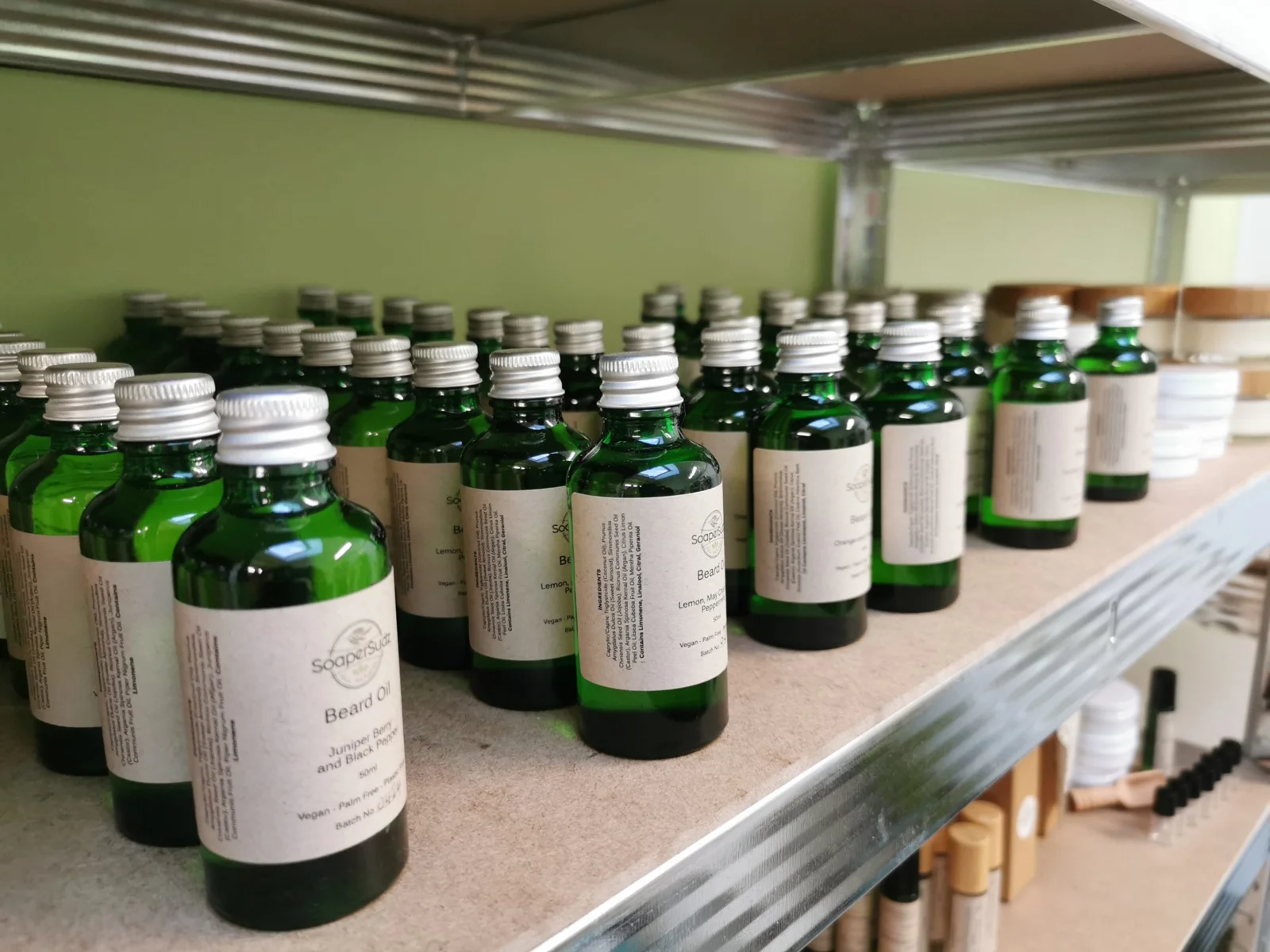 Bottles of SoaperSudz oils lined up on a shelf