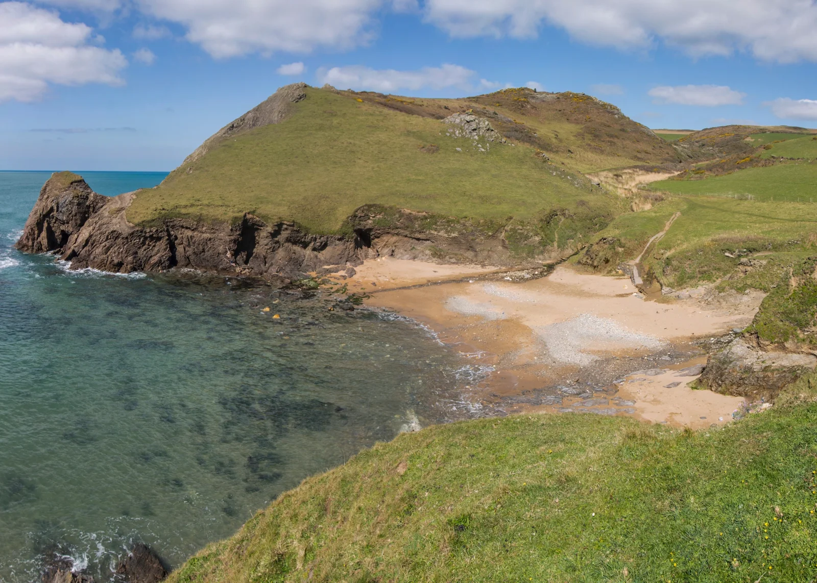 Sandy inlet at Soar Mill Cove framed by rocky headlands