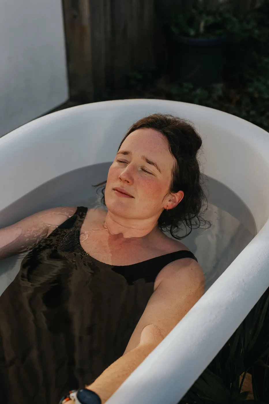 A guest relaxing in a plunge bath at the Dartington sauna