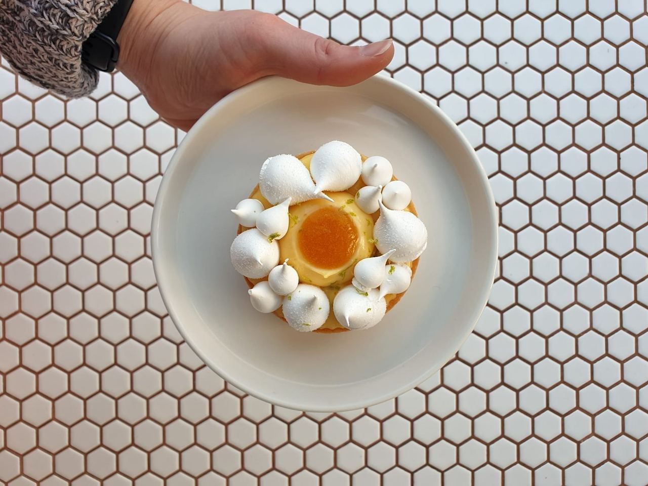 A carefully decorated individual pâtisserie on a white plate