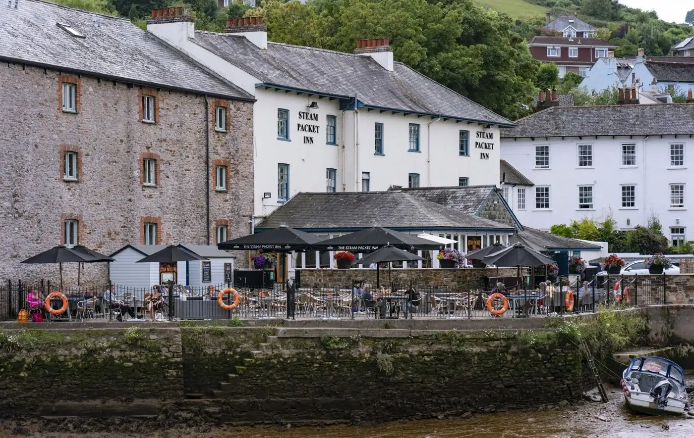 The Steam Packet Inn and its terrace viewed across the river