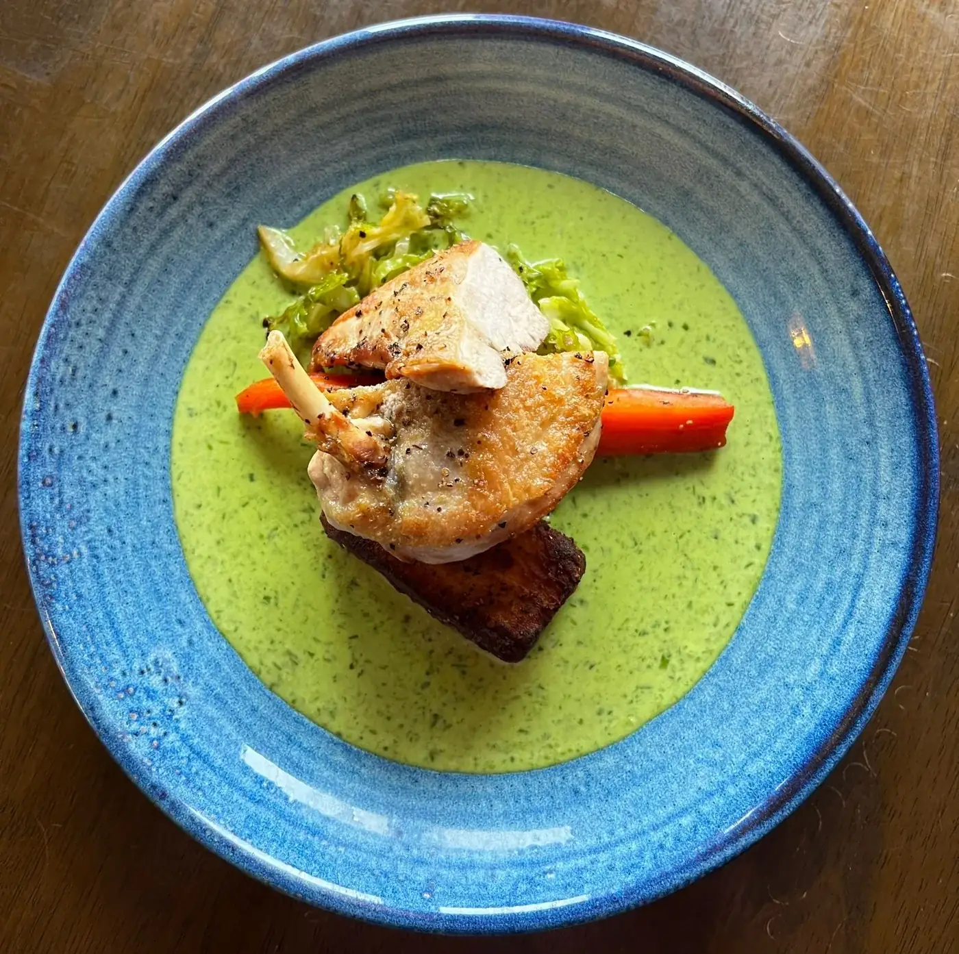 A carefully plated fish dish with green sauce at The Steam Packet Inn