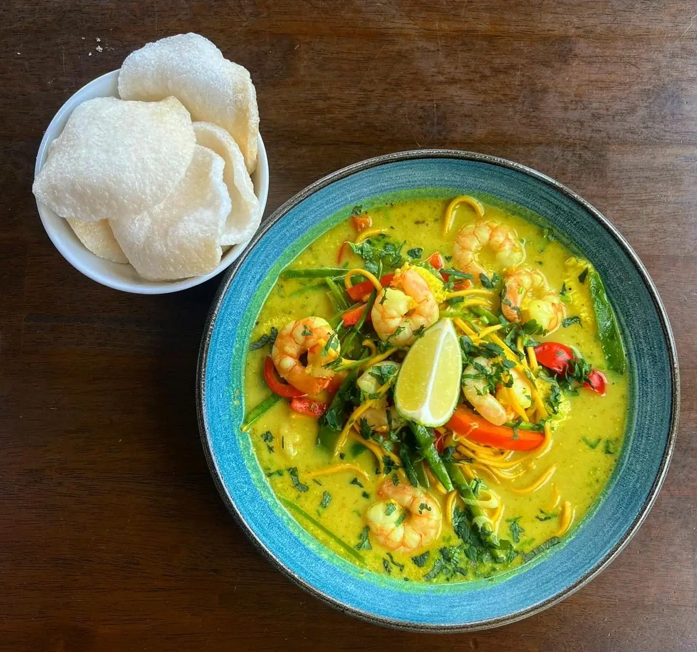 A bright curry-style dish with rice and crackers at The Steam Packet Inn