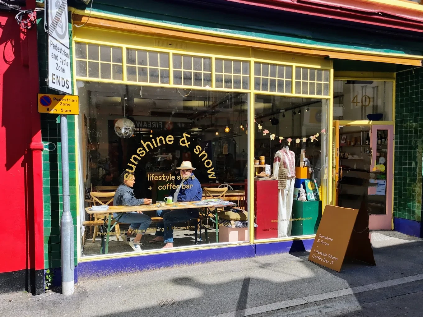 Sunshine & Snow’s yellow-framed shopfront and window seating