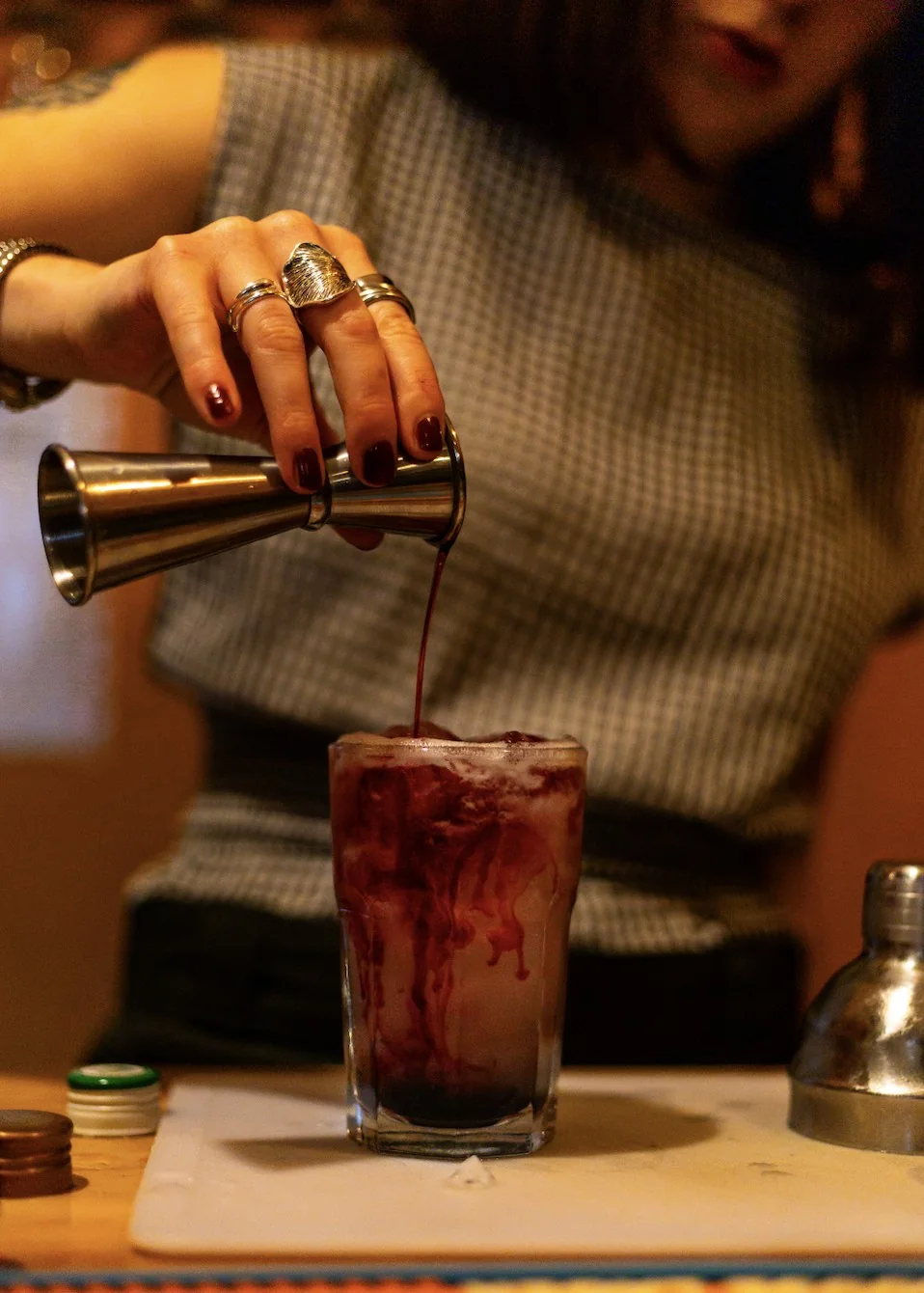 A bartender pouring a colourful drink at Tamarind Tree