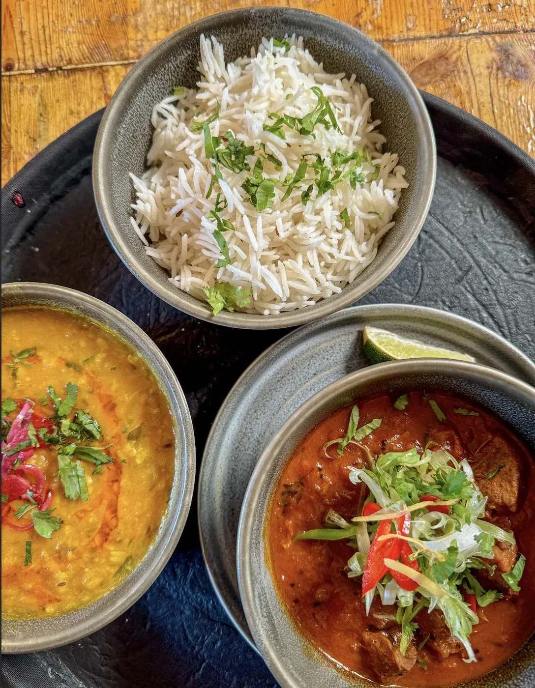 Rice and colourful curries in bowls at Tamarind Tree