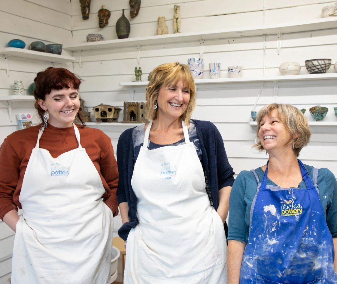 The Tarka Pottery team in aprons inside the studio