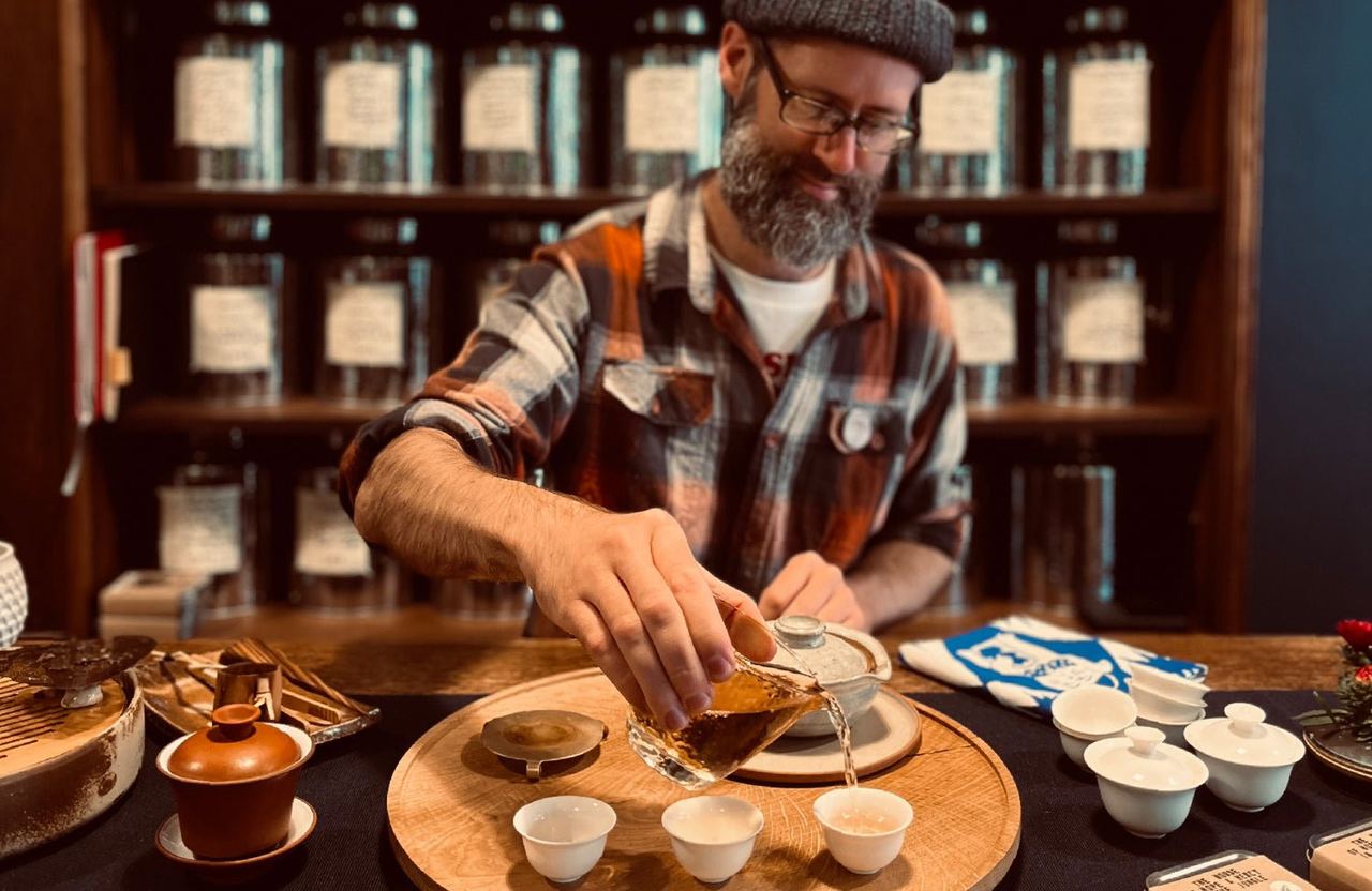Tea being brewed at a wooden table inside the Exeter tea boutique