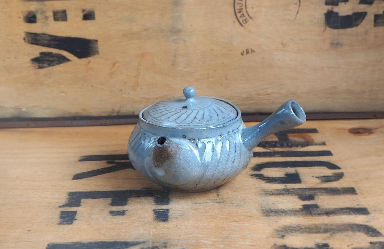 A handmade blue teapot stocked by the tea boutique