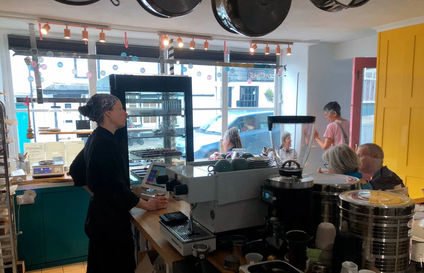 The chocolatier talking to customers inside Tempt