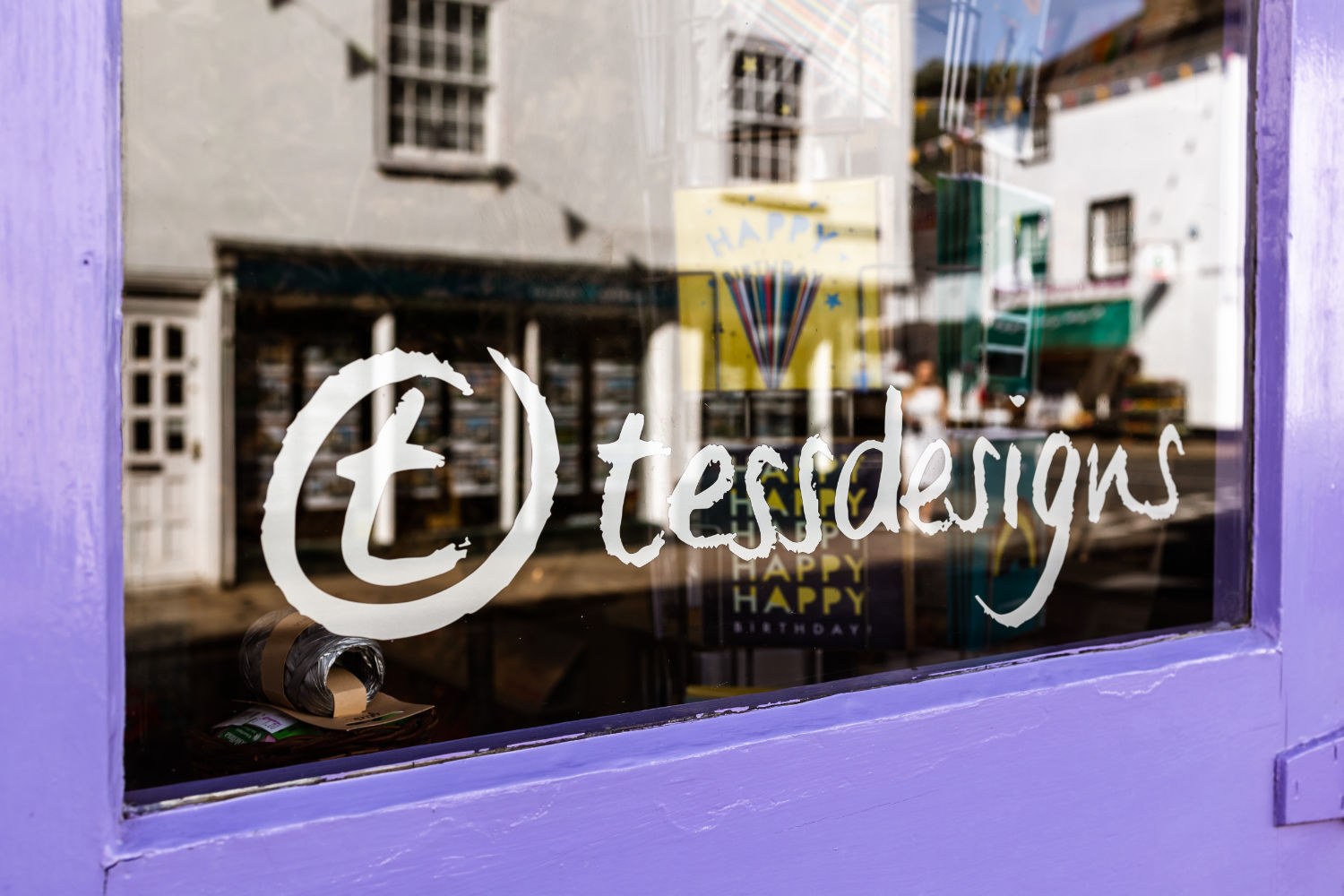 The tessdesigns name on a window framed by the shop’s lilac-painted frontage