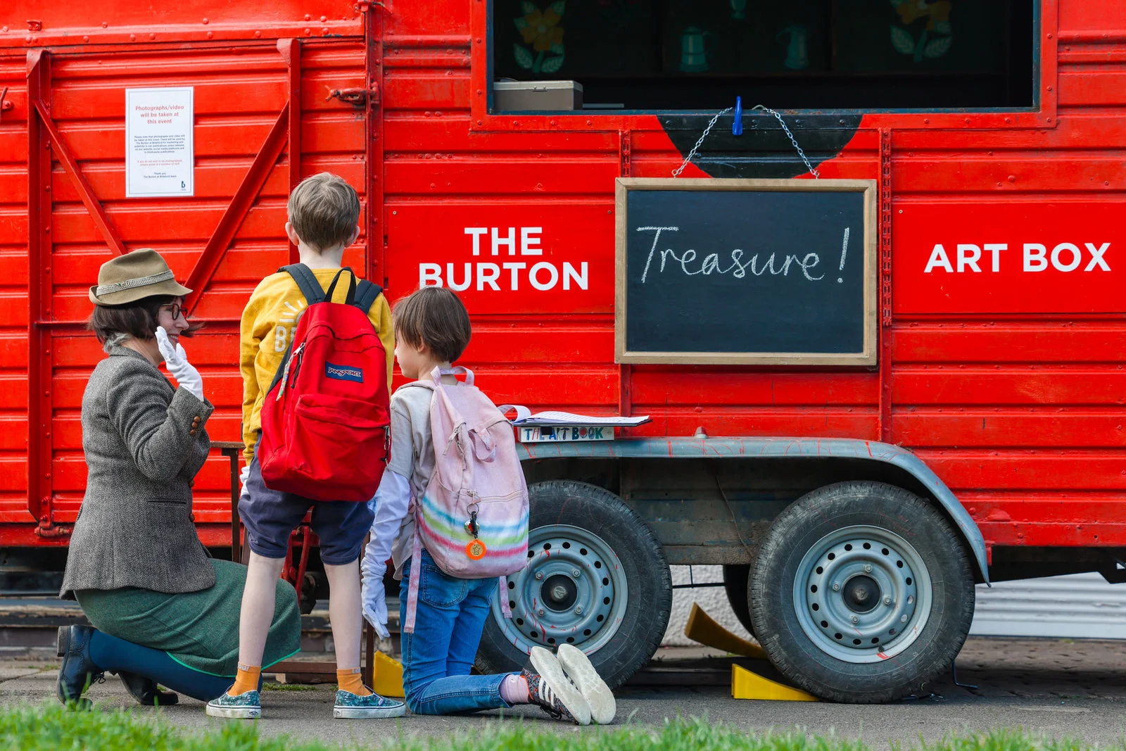 Families beside the red Burton Art Box trailer