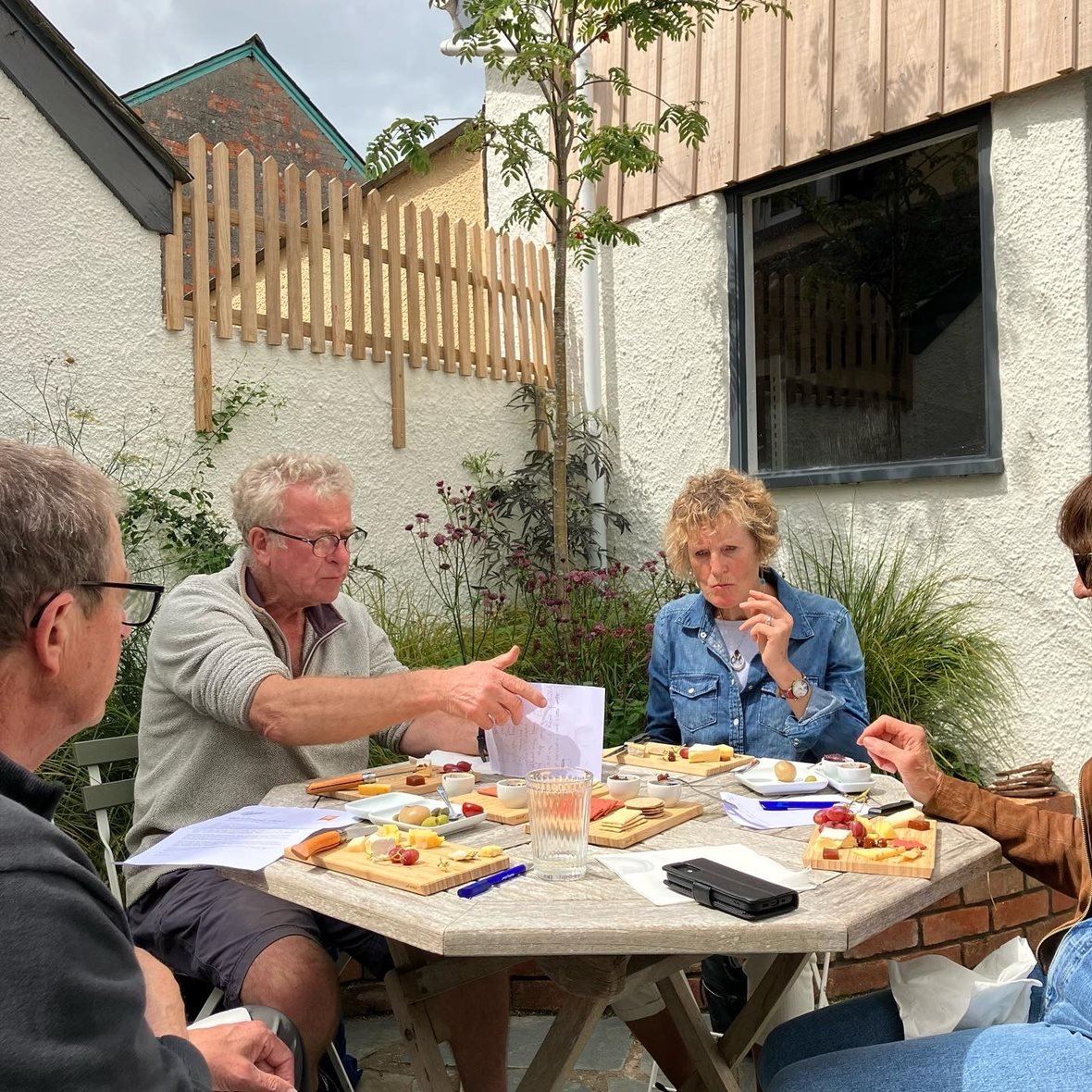 Visitors eating cheese in The Cheese Shed courtyard