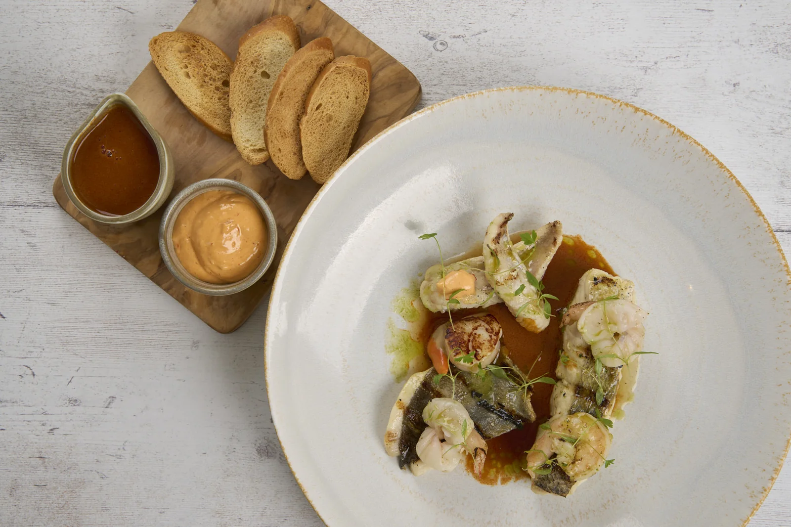 Seafood dish with toasted bread and sauces at The Cricket Inn