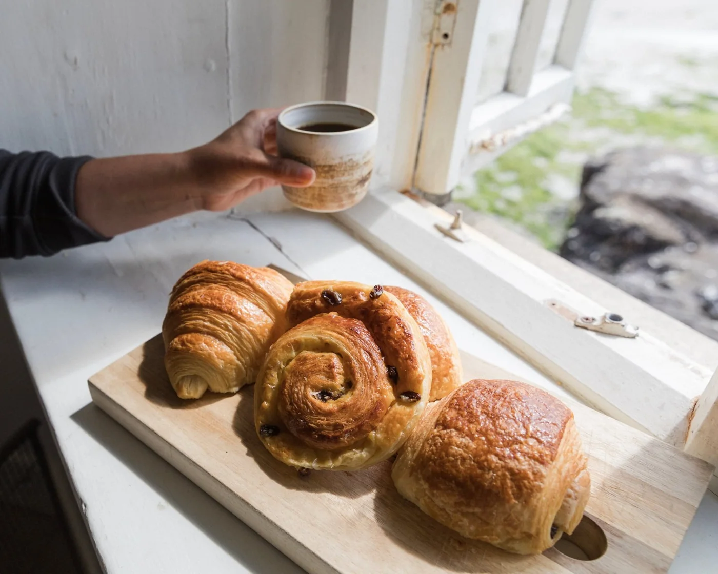 Pastries and coffee by a window at The Curator